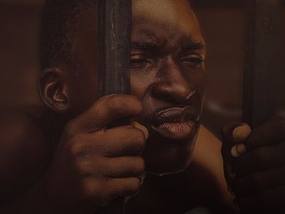 Close view of a man's hands gripping a bar.