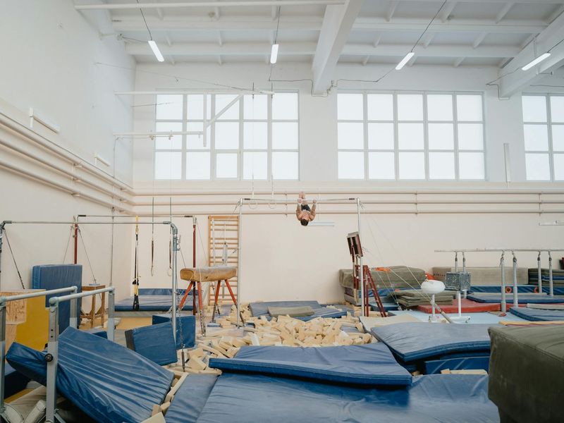 Minimalist training space with natural light and dark mats.